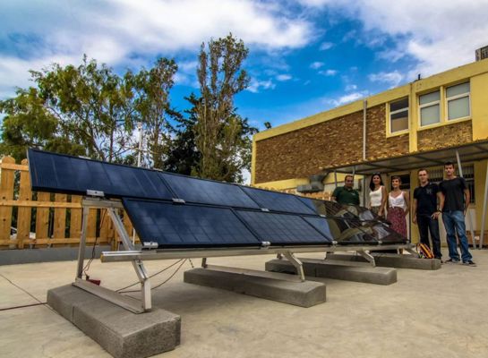 five people near a solar panel