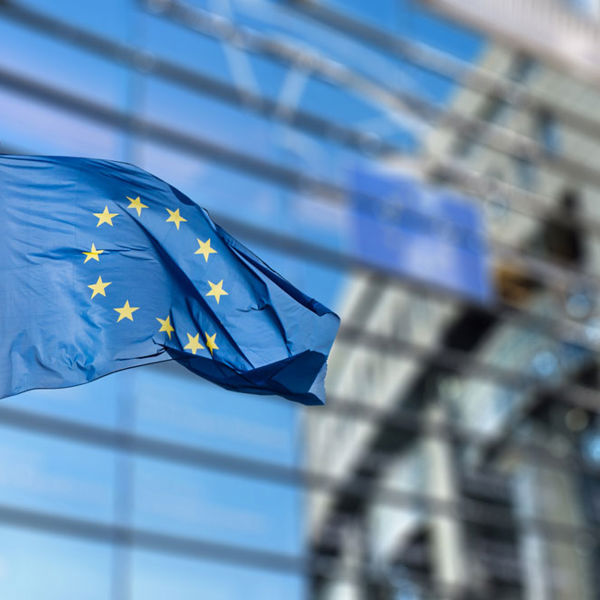 European union flag on skyscraper building background.