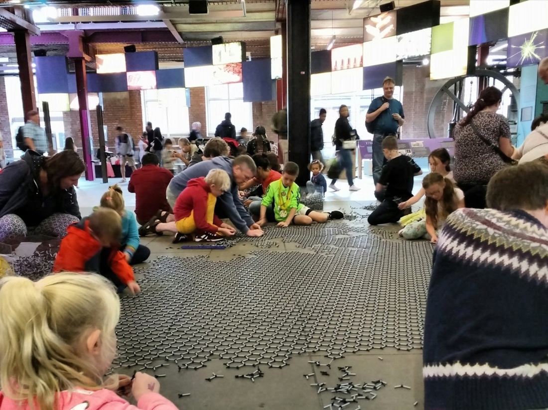 children and families create a graphene carpet