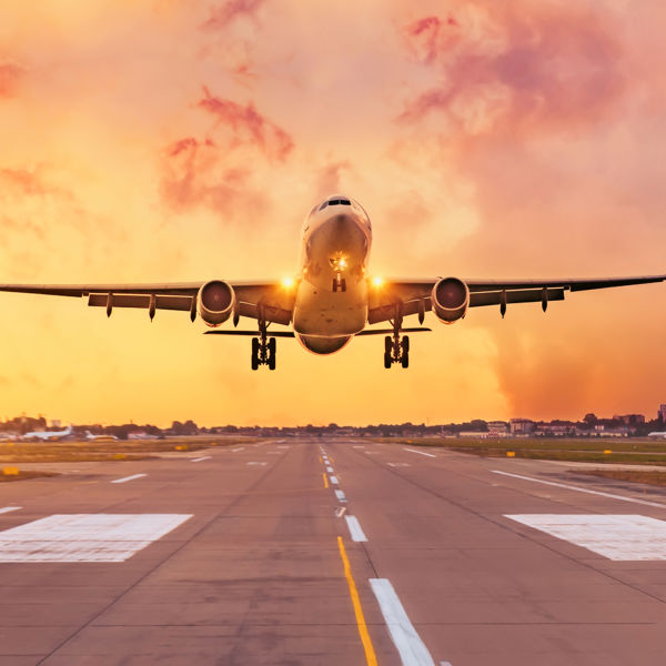 airplane taking off in sunrise