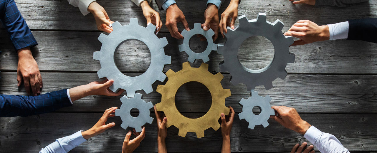 hands collaborating to make the wheels turn